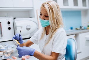 A dental technician crafting dentures