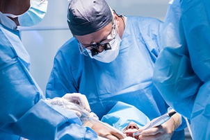 Dentists performing a dental implant surgery