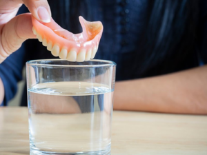 Close up of patient about to soak their denture